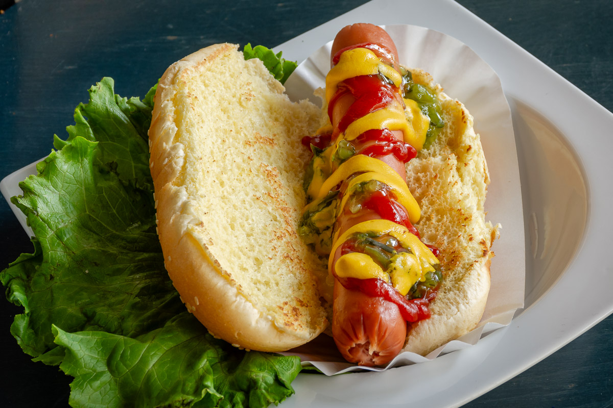 Hot Dog covered in mustard ketchup and relish
